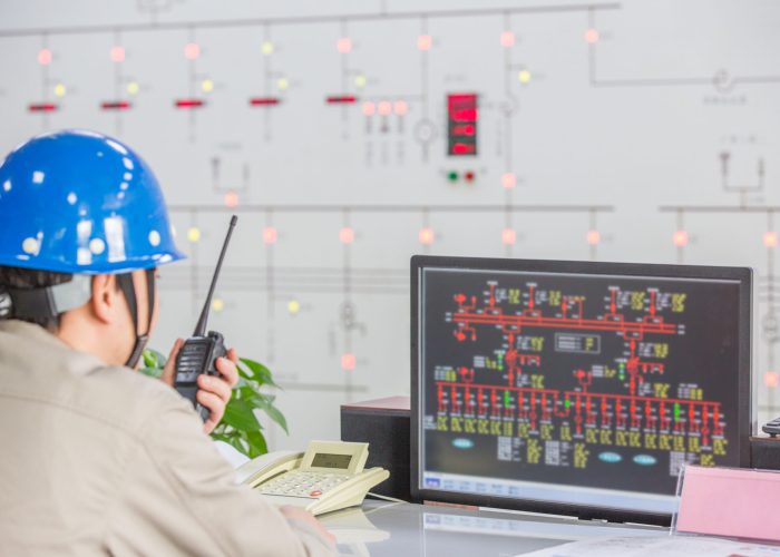workers in control room of a factory.